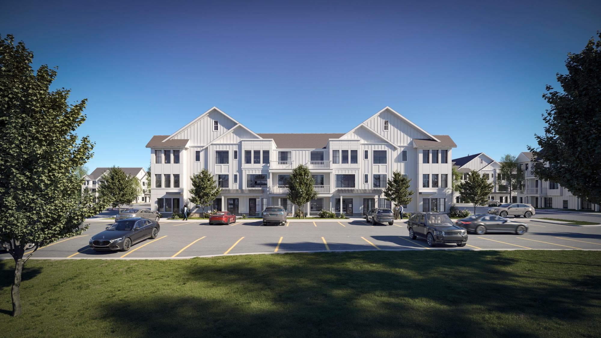 A luxury apartment building with private balconies and a large parking area surrounded by trees has multiple cars and pedestrians.